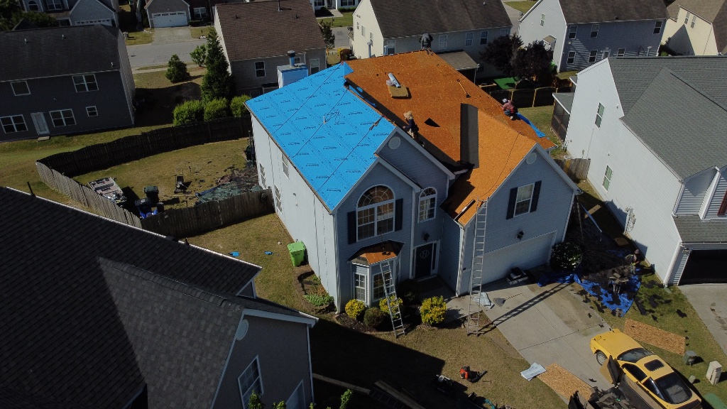 Ice & water shield in valleys, blue underlayment rolling across the deck
