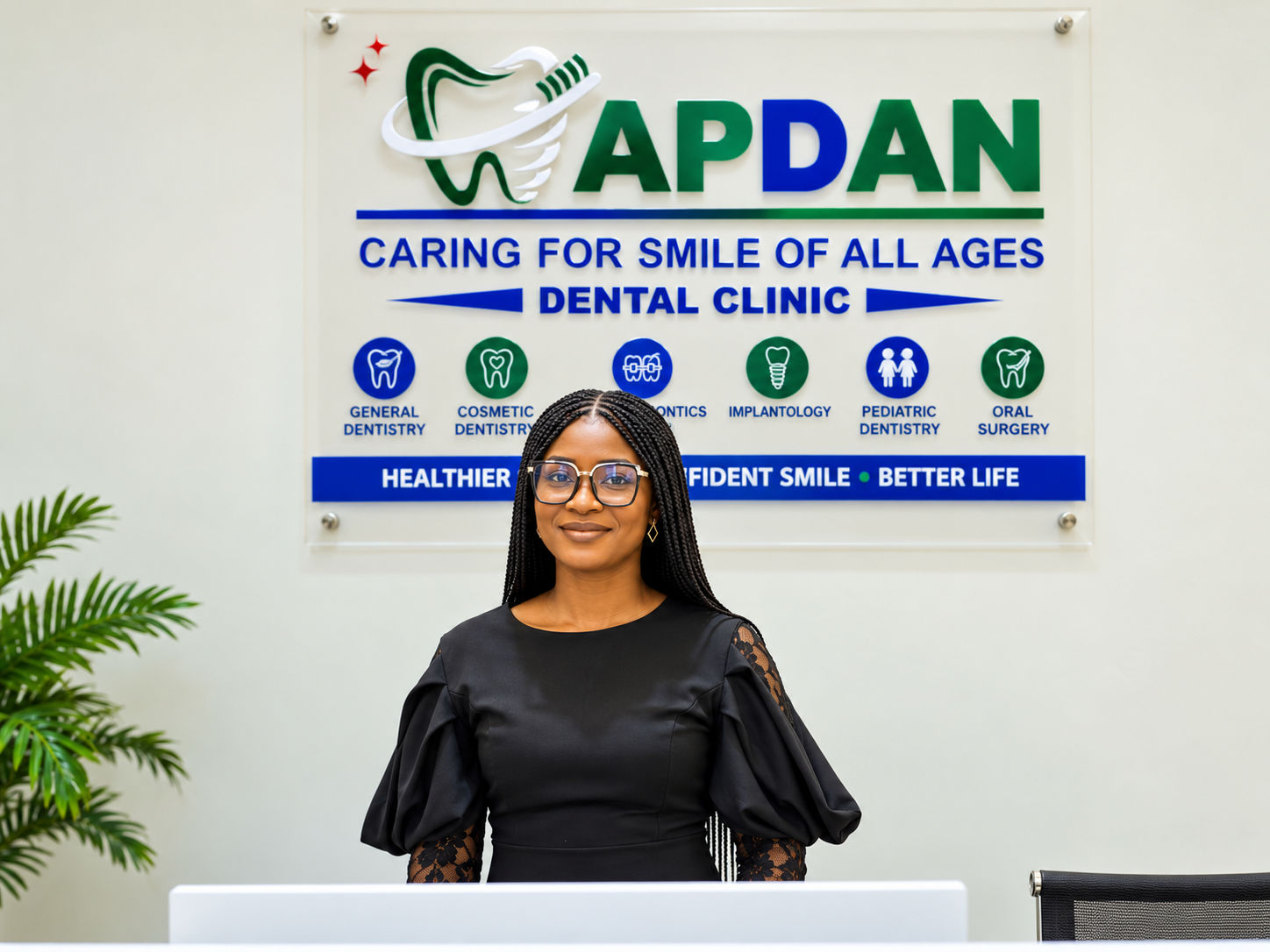 Our receptionist welcoming you under the APDAN Dental Clinic sign