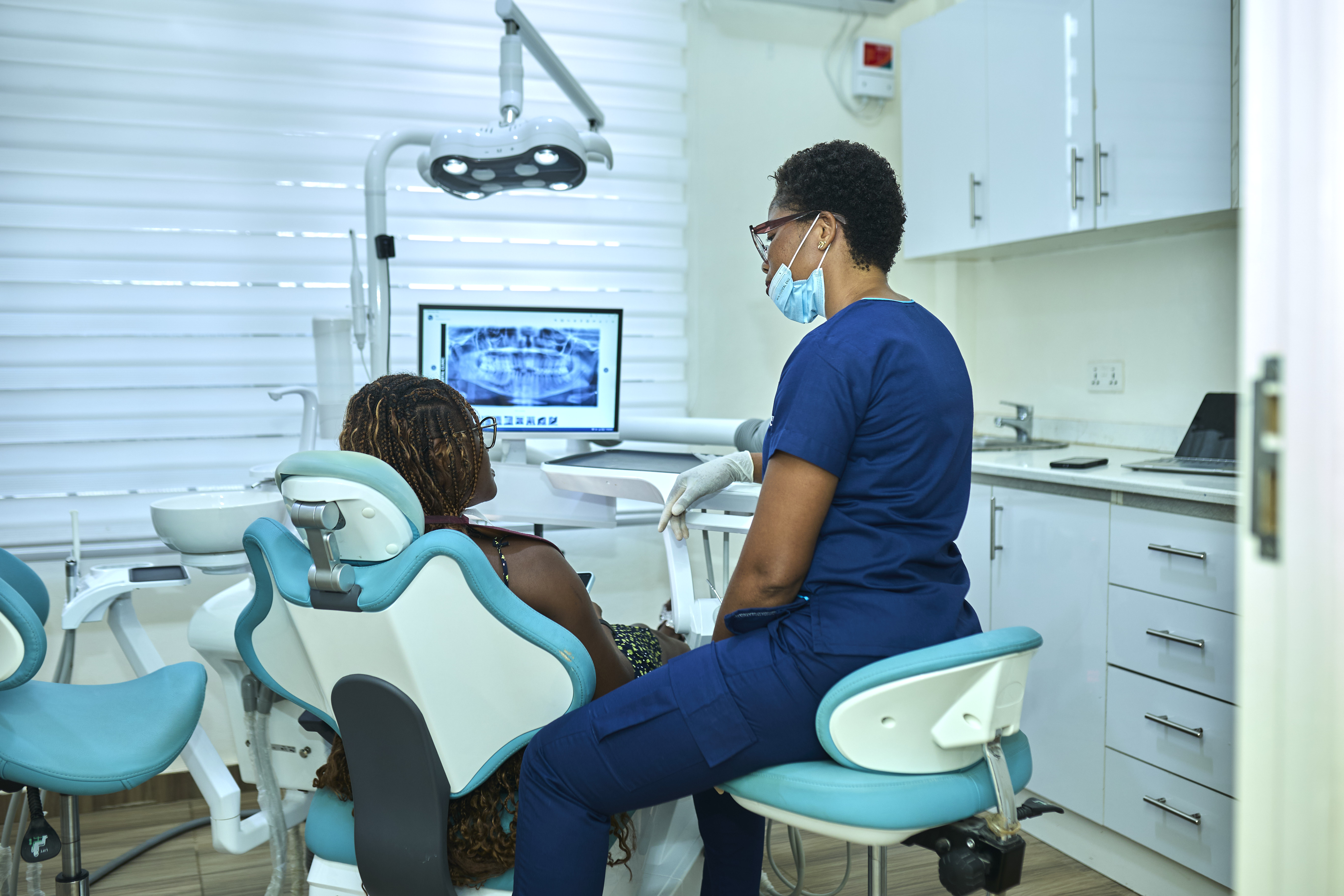 APDAN dental team reviewing X-rays with a patient