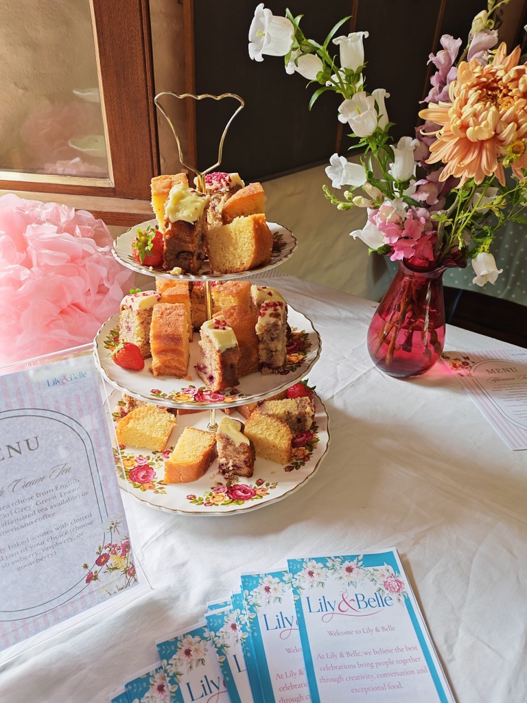 Afternoon tea at a craft course in Lostwithiel — vintage cake stand with sponge cakes and fresh flowers