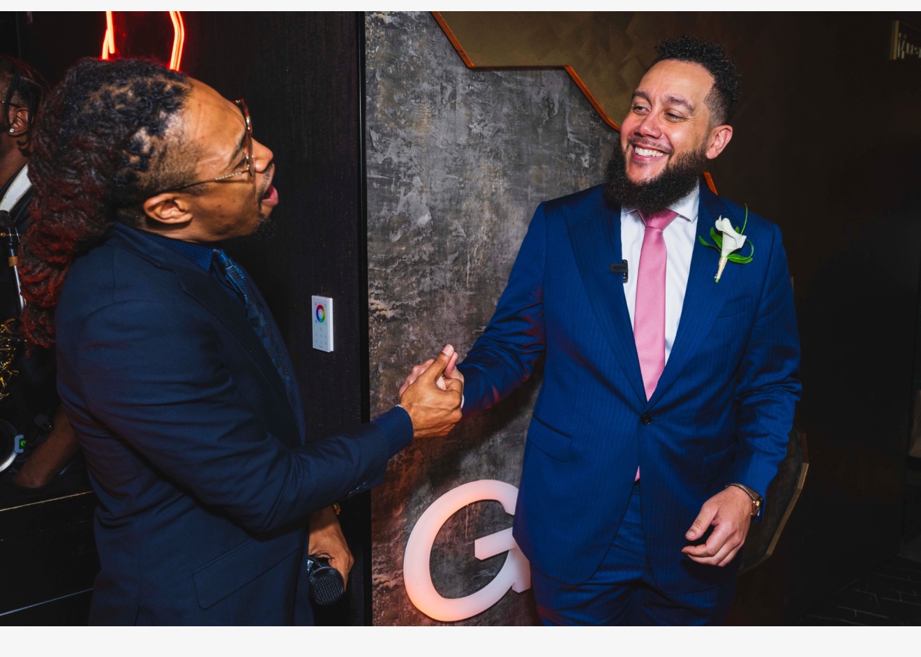 Lance Hawkins greeting a guest at a professional event