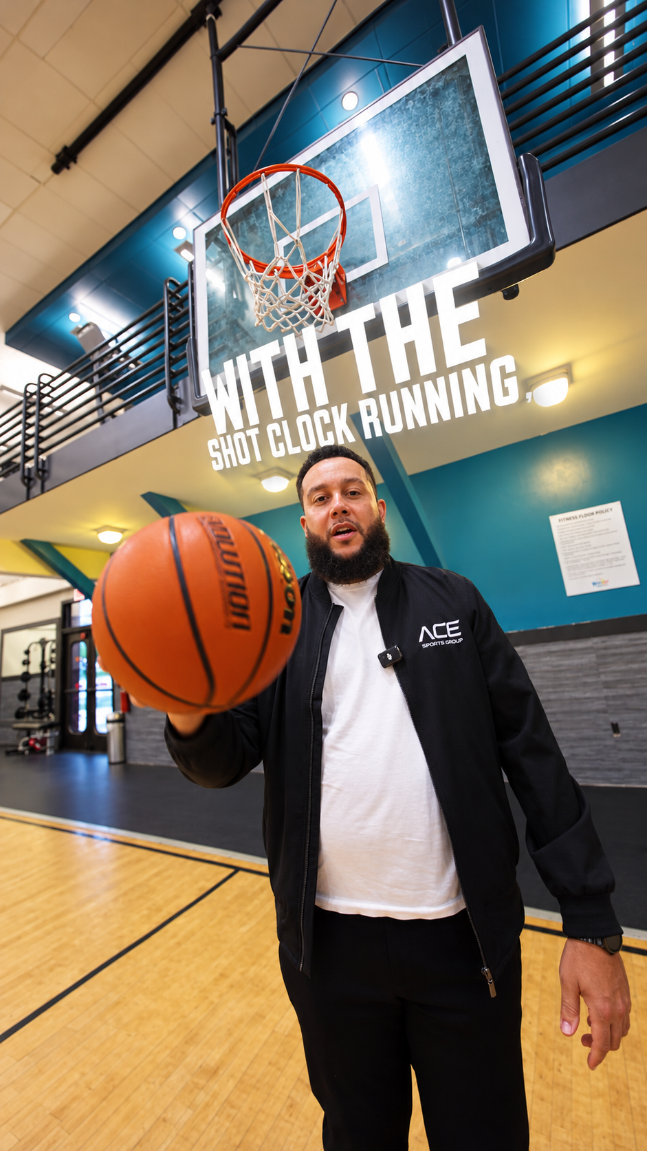 Lance Hawkins presenting a basketball in a gym