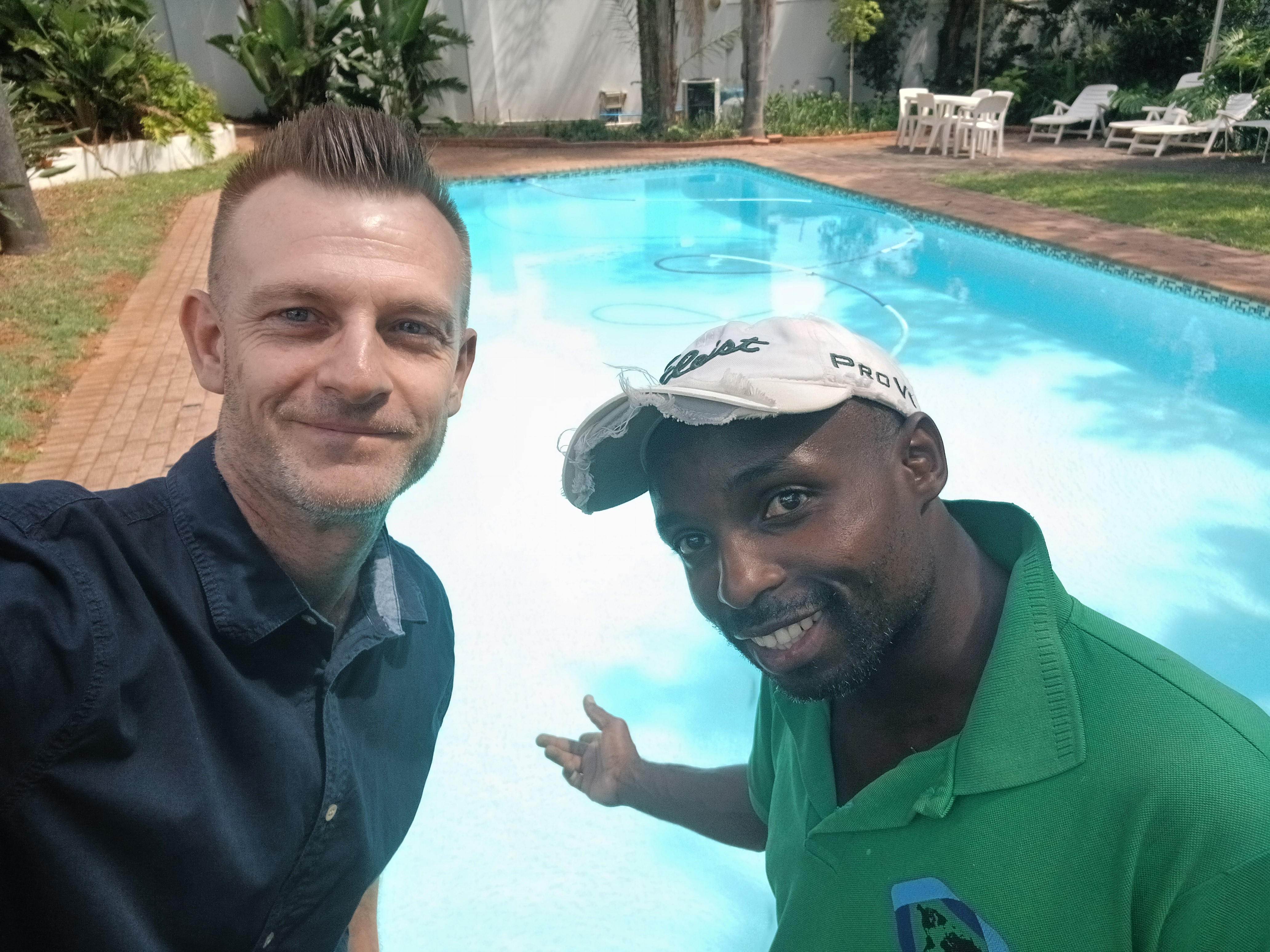 Pool Care team โ Wouter (owner) and Mr. Trust (pool technician) poolside