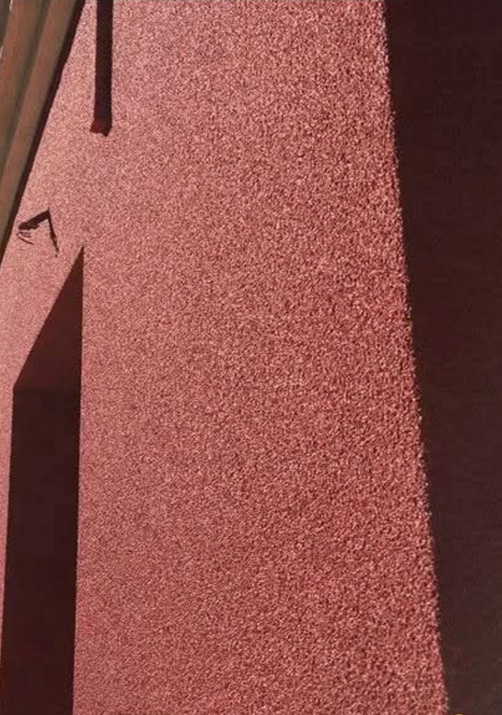 VIPEQ cork spray textured finish on ICF facade — close-up detail