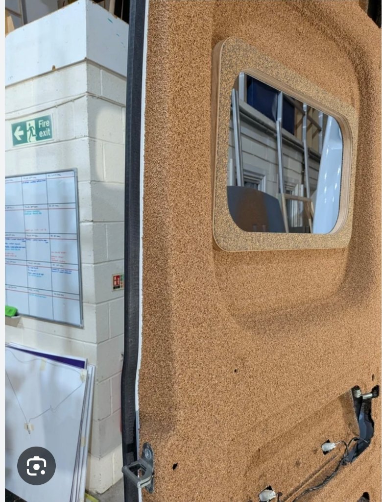 Van door insulated with cork spray showing window cutout