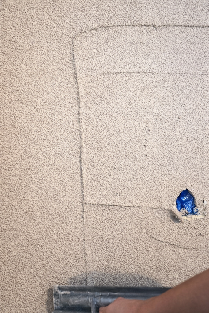 Cork insulating plaster applied by trowel to wall