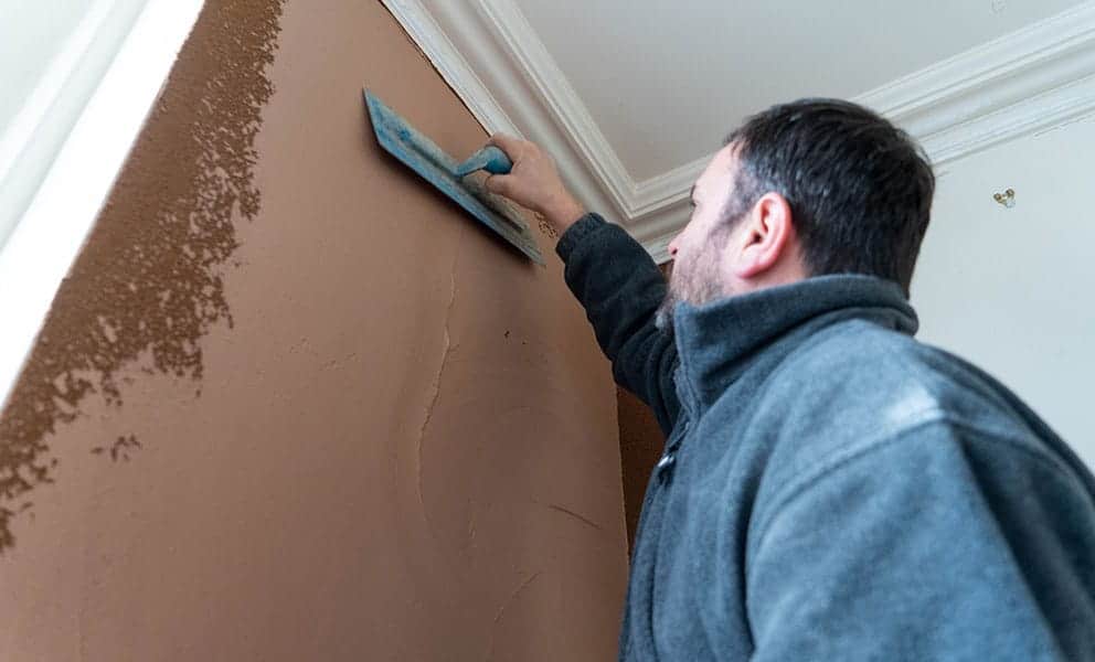Cork insulating plaster applied by contractor to internal wall