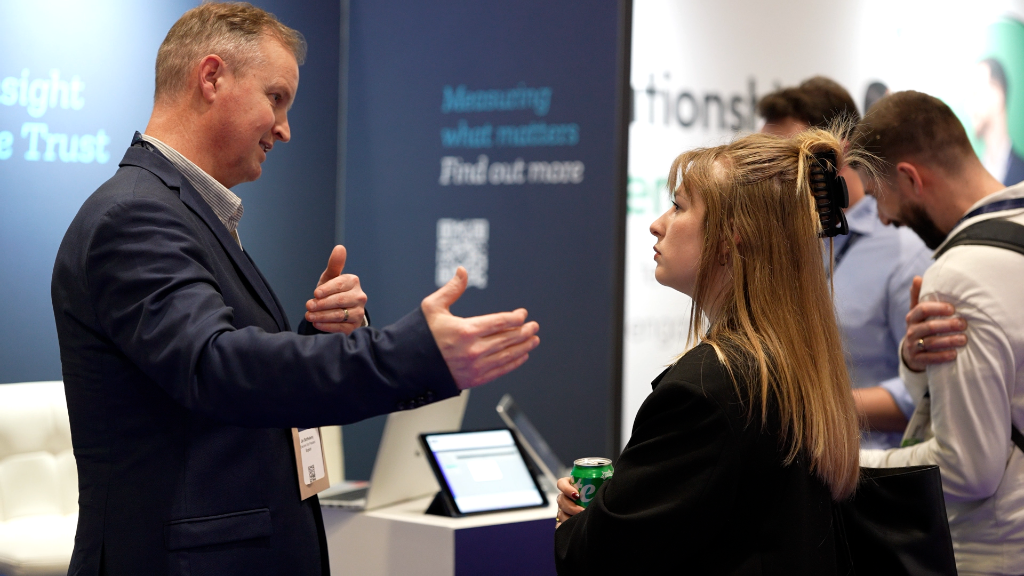 Explori researcher in conversation with a delegate at an event