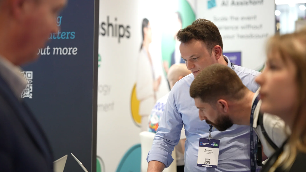 The Explori team in conversation with visitors at the booth
