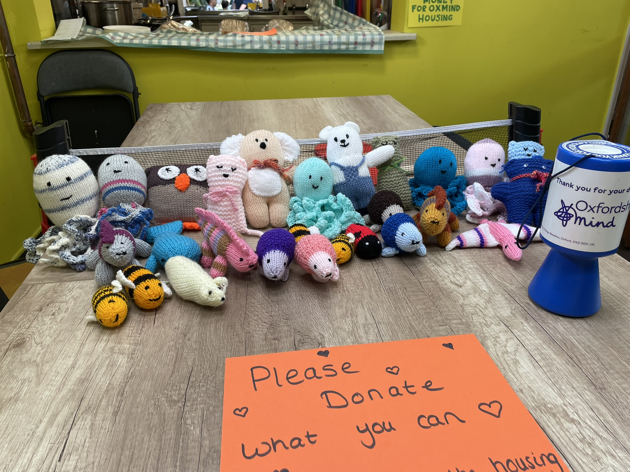 Handmade crocheted toys with Oxfordshire Mind donation tin
