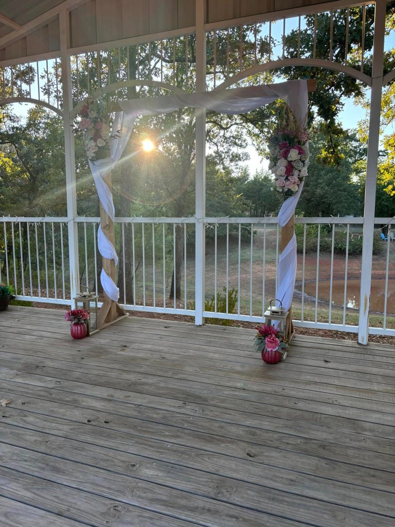 Floral arch at sunset on the pavilion deck