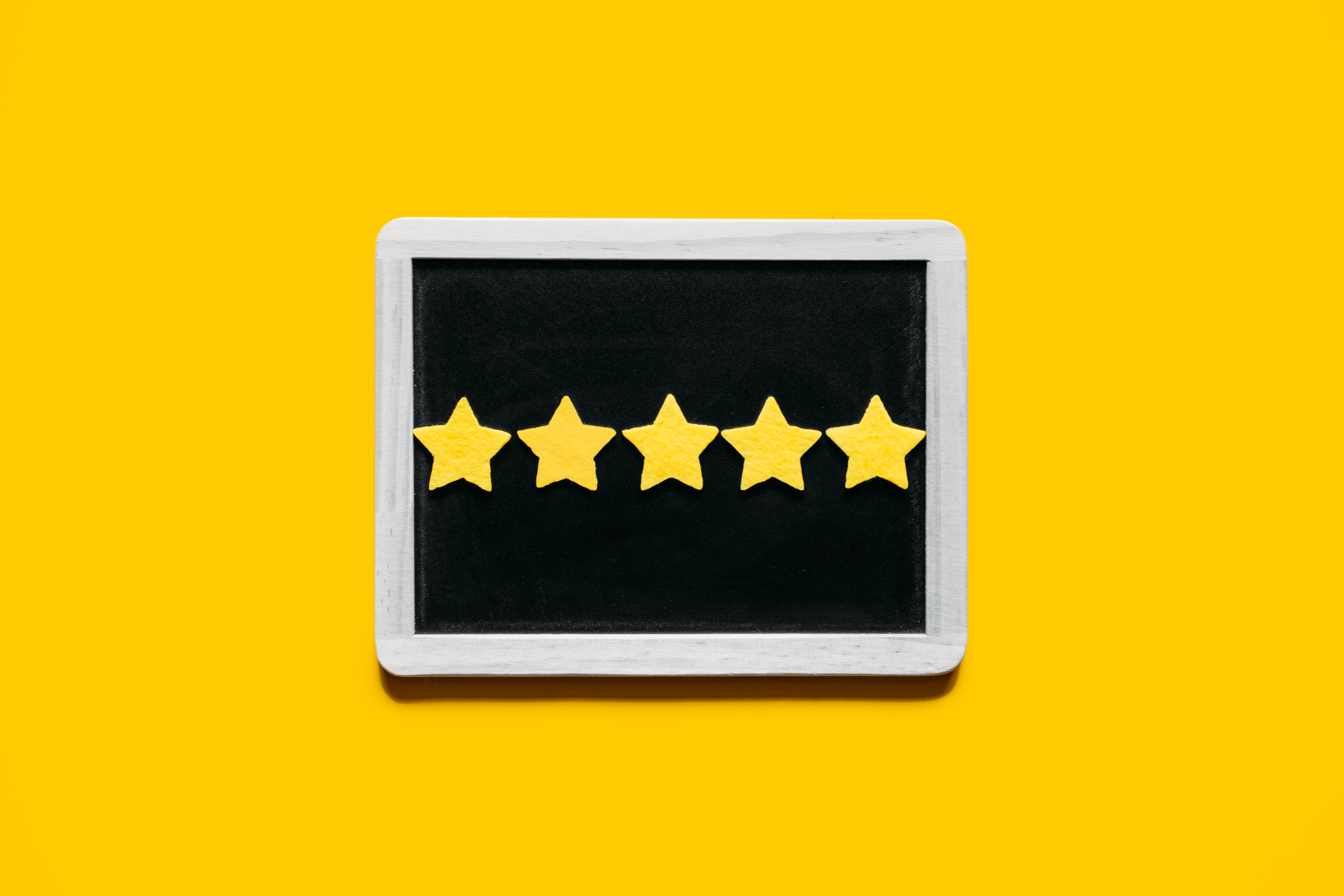 Five yellow stars on a chalkboard