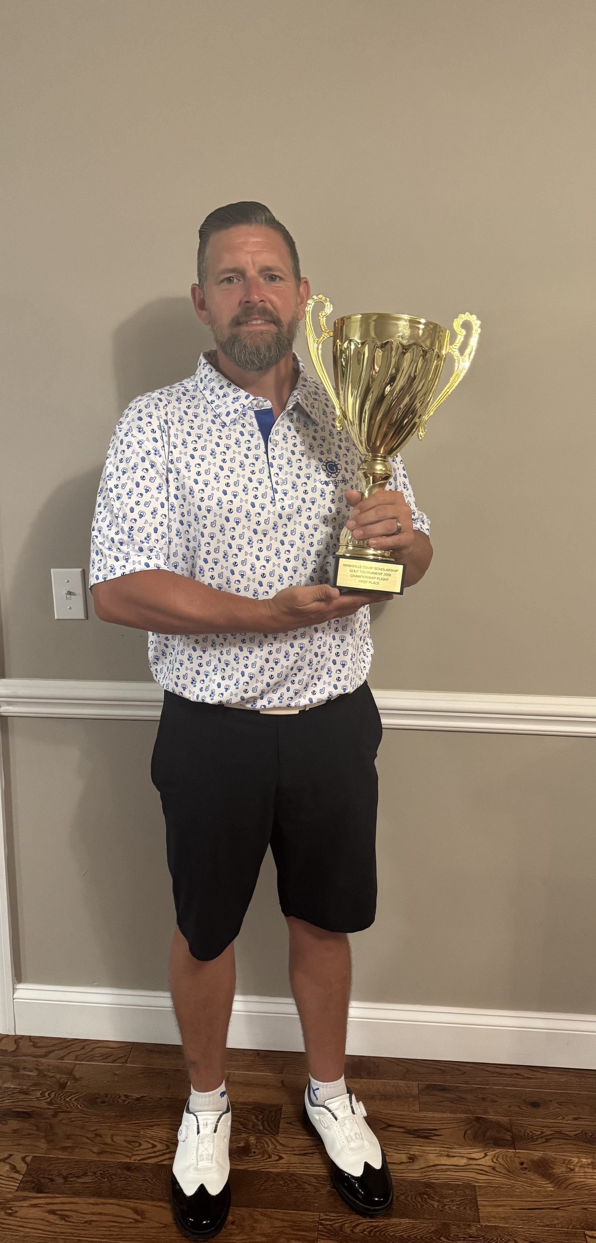Co-Owner Ellsworth Sheldon holding the 2026 Nashville Co-op Scholarship Golf Tournament championship trophy