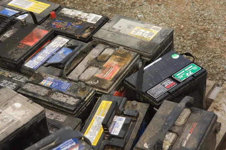 Stacks of spent lead-acid car batteries ready for recycling