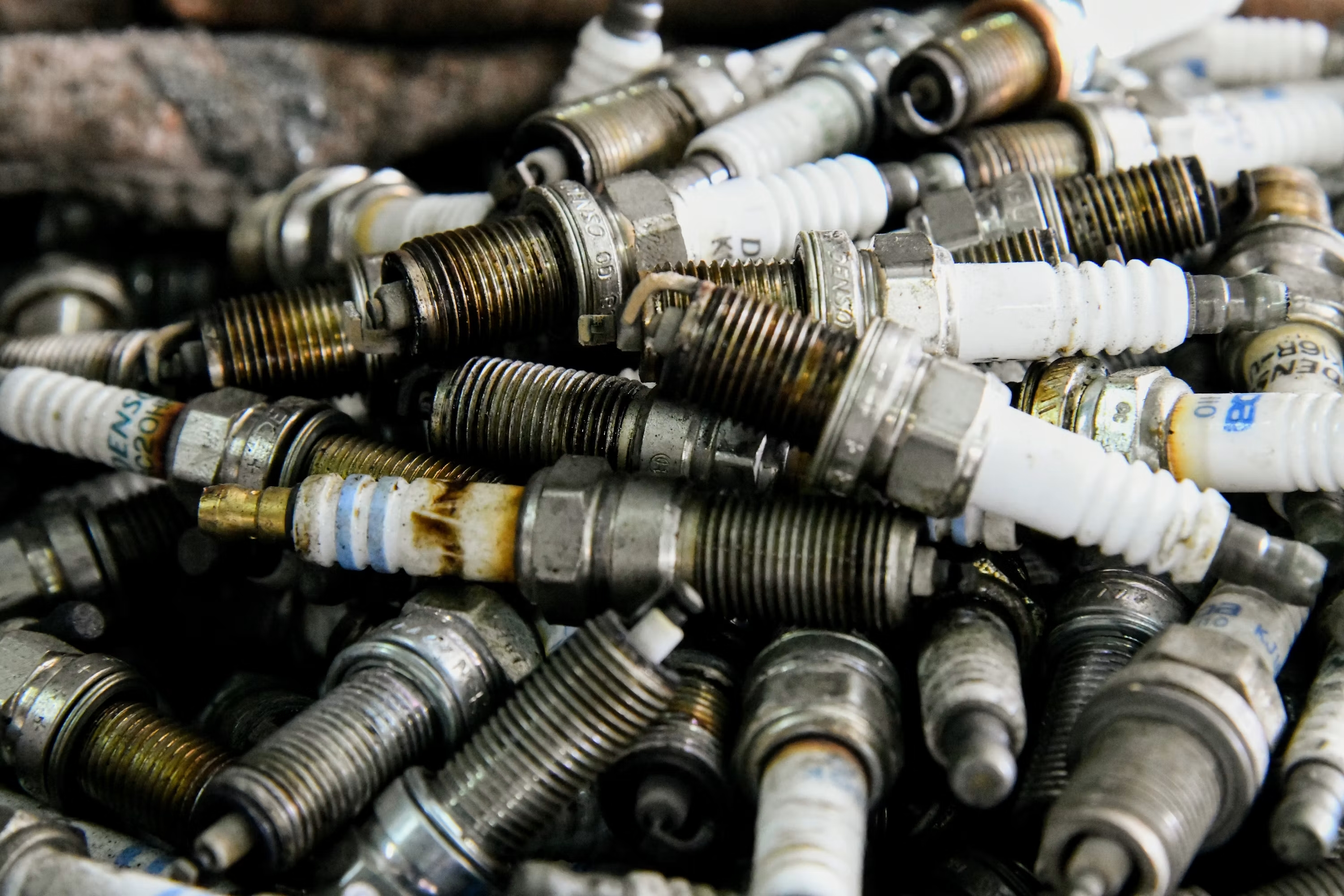 Collection of used iridium and platinum spark plugs
