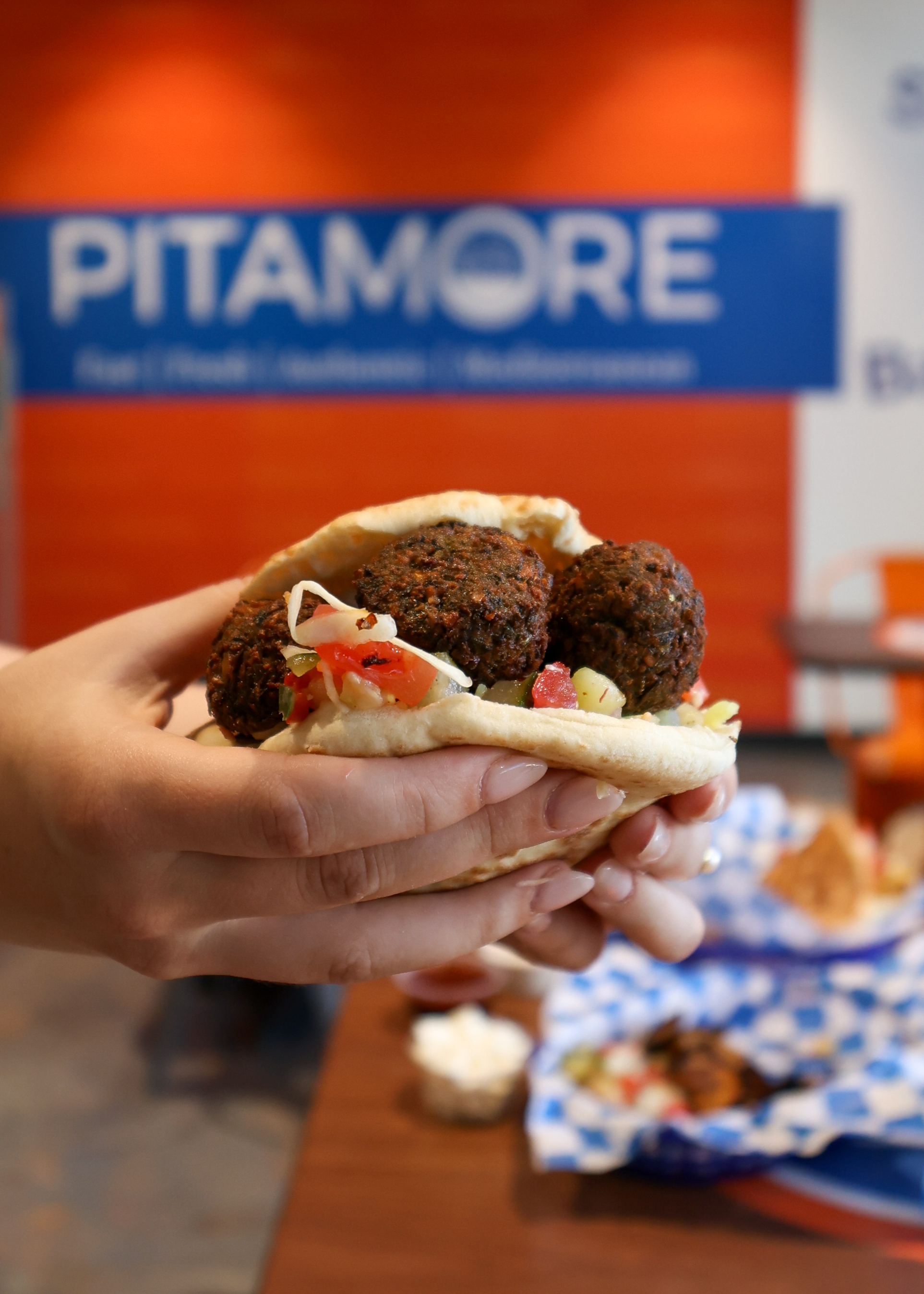 Falafel pita held up, Pitamore