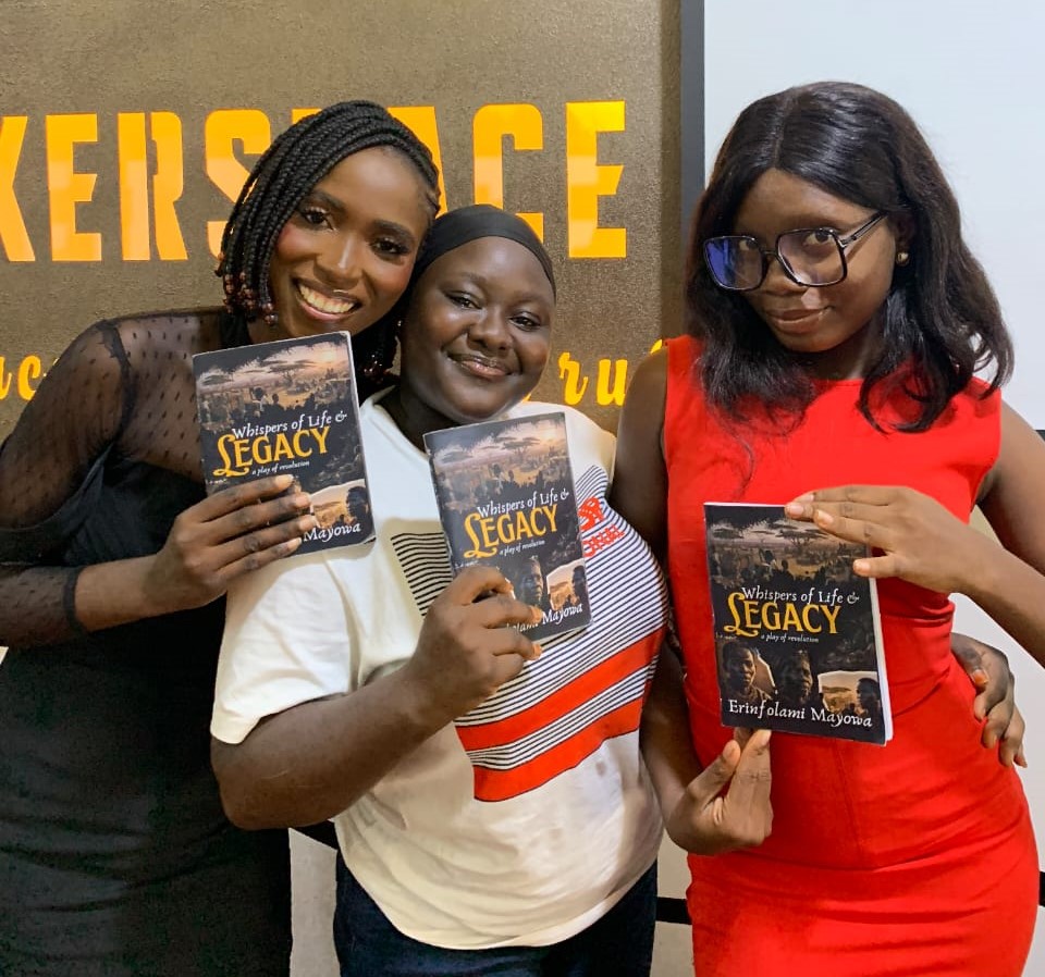 Three women holding Whispers of Life and Legacy