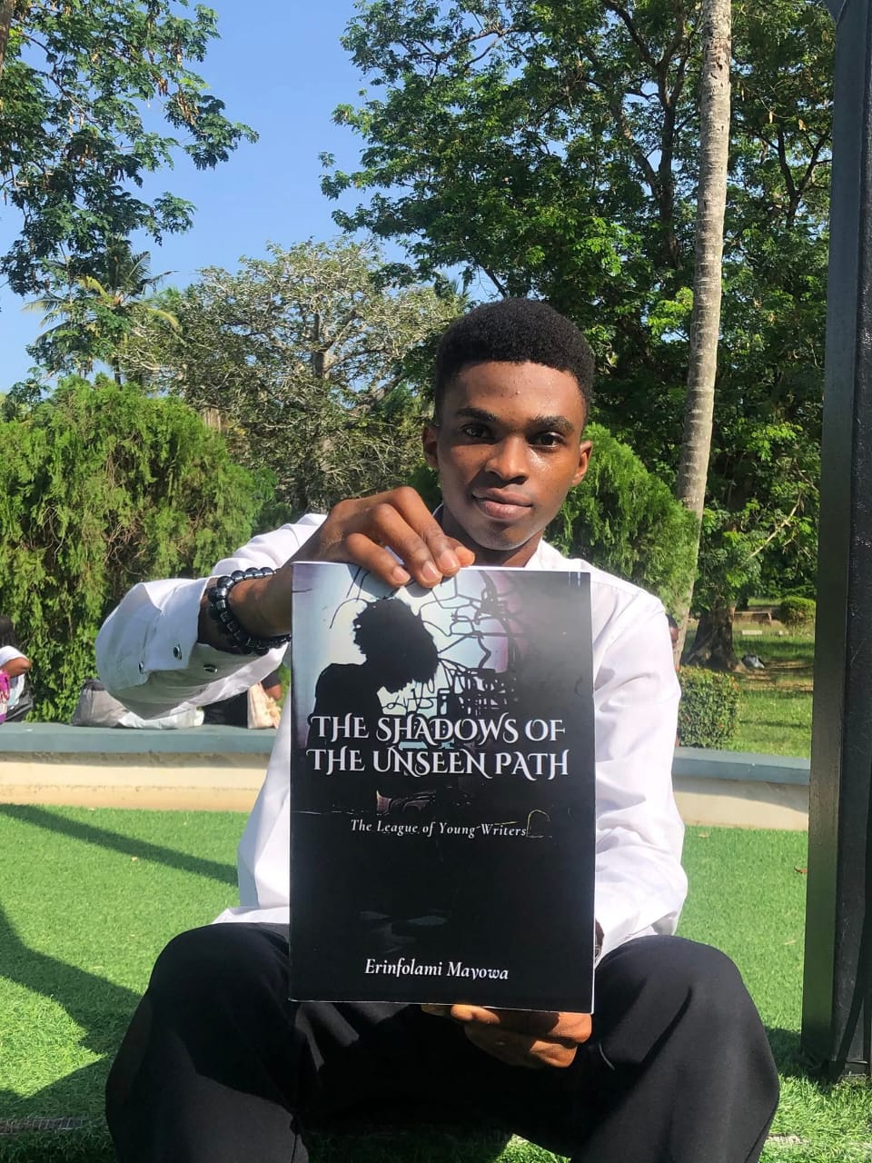 Founder holding the book