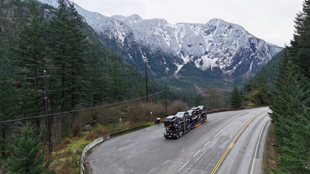 Car carrier truck driving through the Rocky Mountains