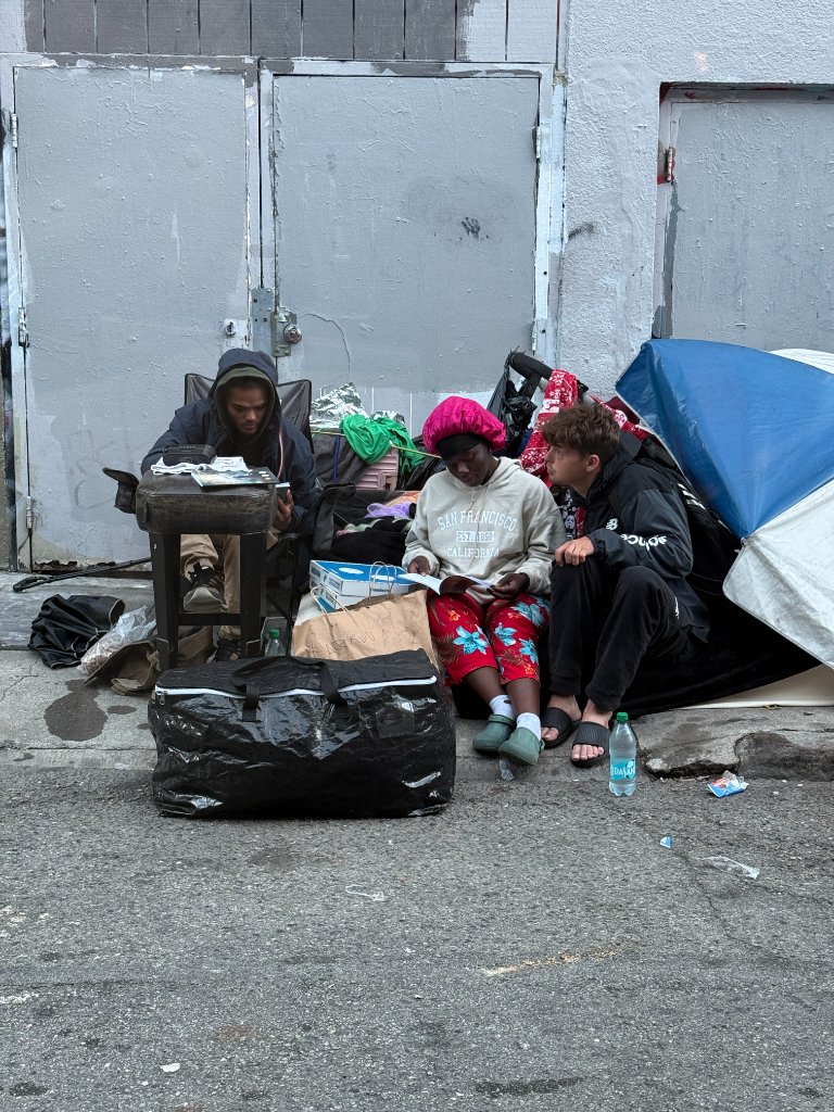 Community members reading together during San Francisco homeless outreach