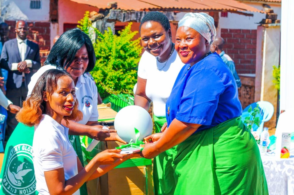 Women of the Destiny Global Care Foundation receiving gifts during a community program in Malawi