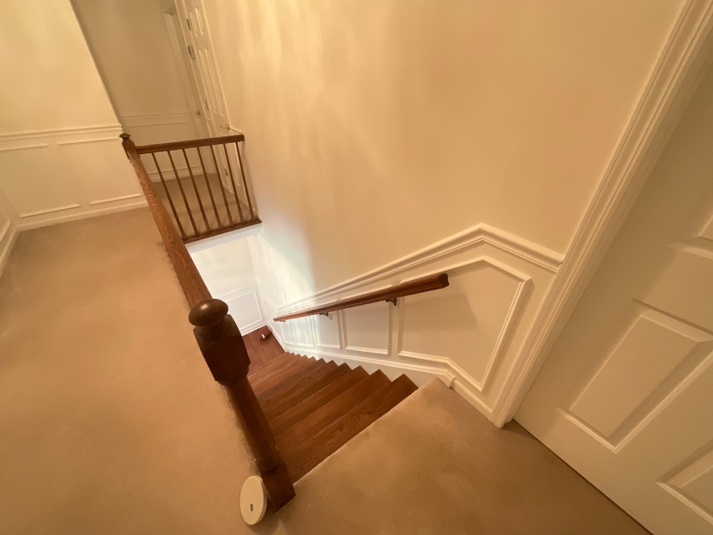 Wainscoting hallway with staircase