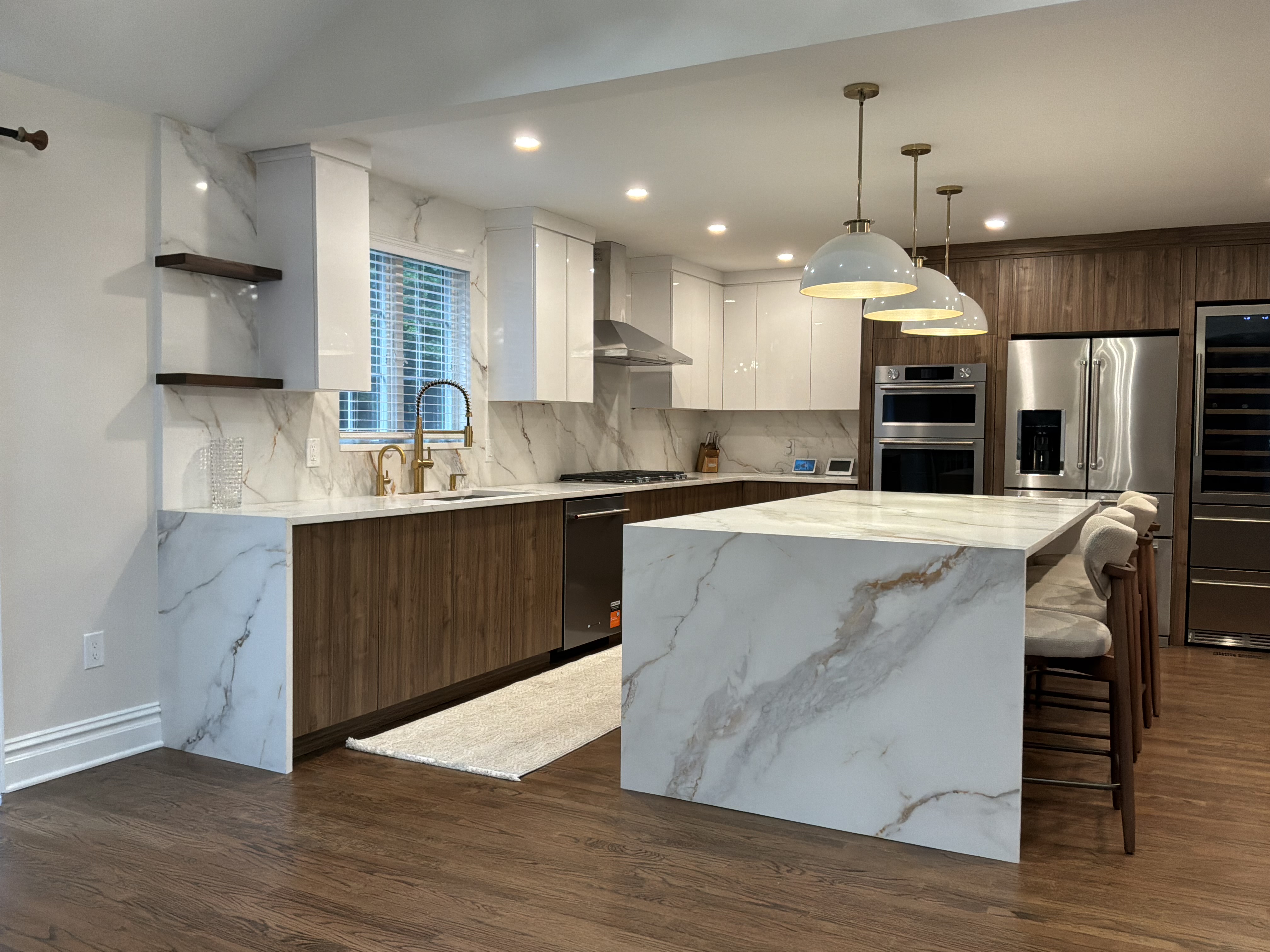 Modern kitchen with waterfall marble island and pendant lights
