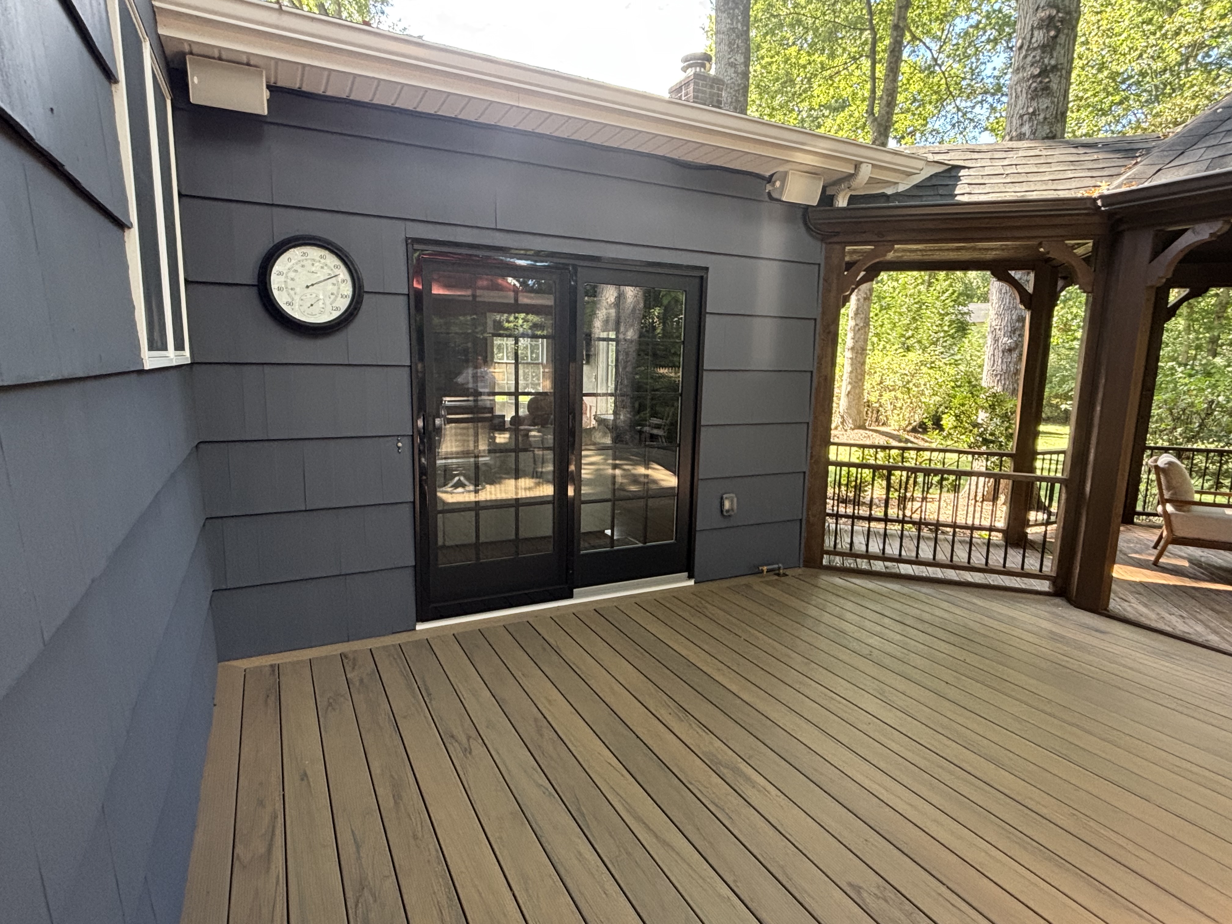 Composite deck with sliding glass door and gazebo posts