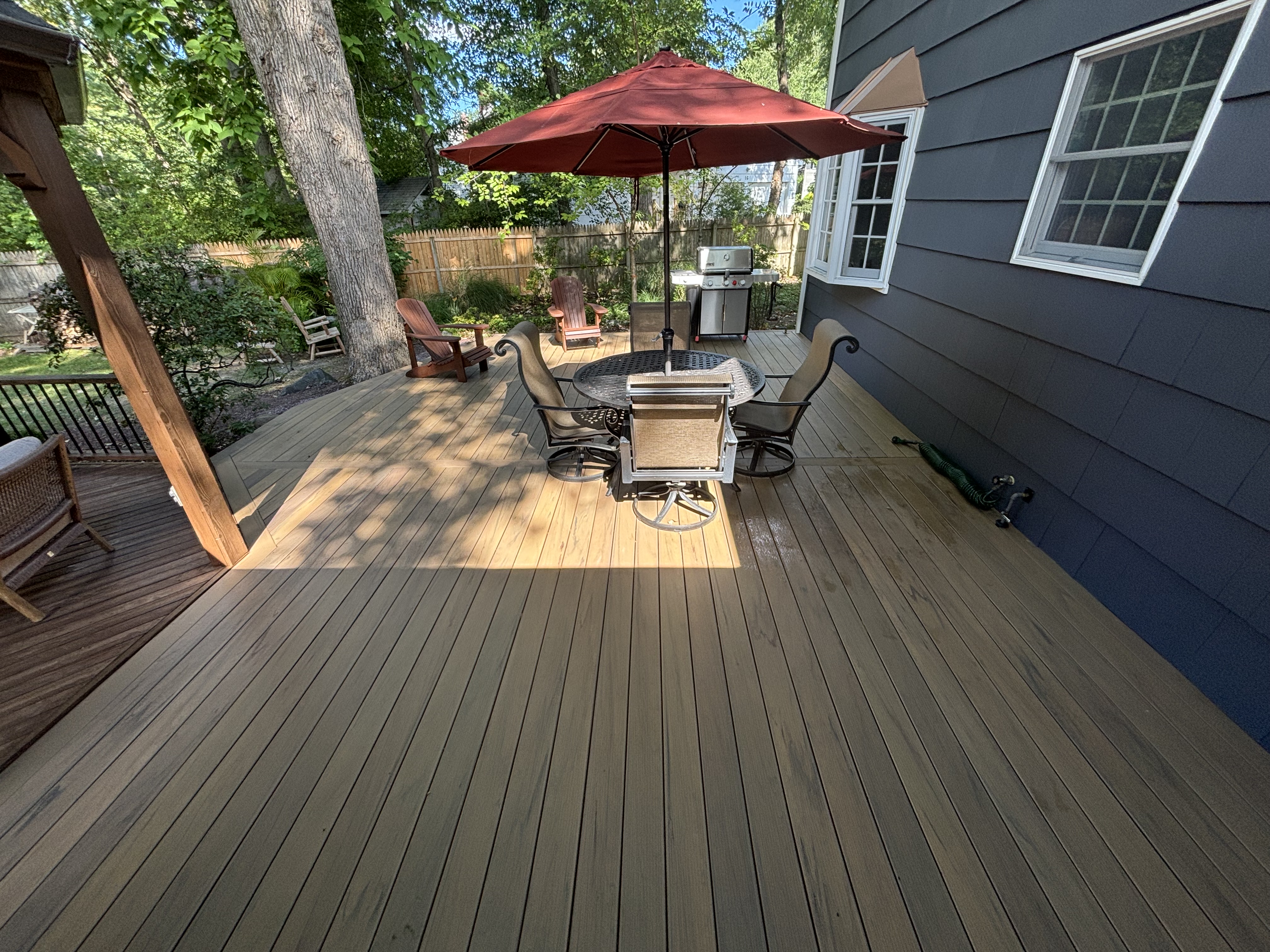 New composite deck with red umbrella dining set