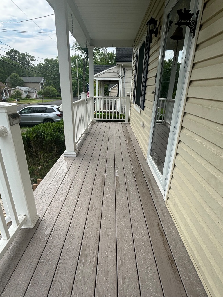 Front porch with composite decking and white railing