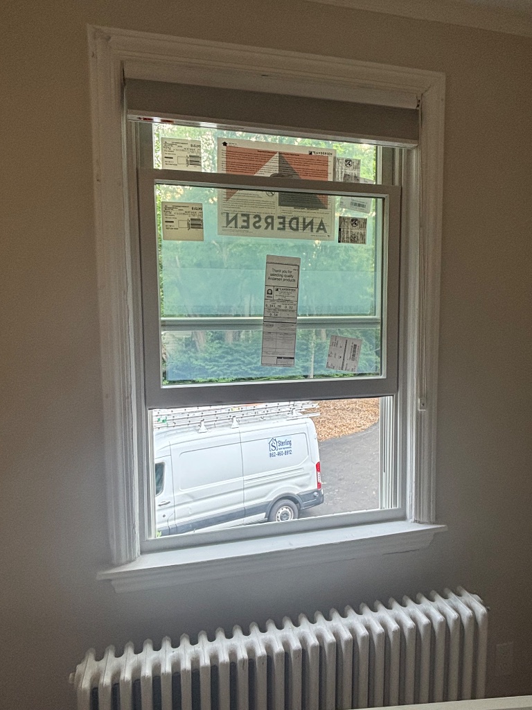 Andersen window installation in progress with Sterling van visible