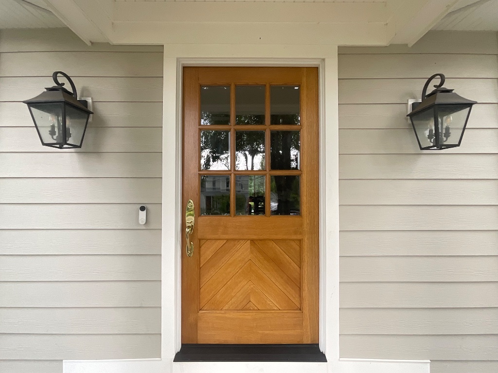 Refinished wooden front door with herringbone detail