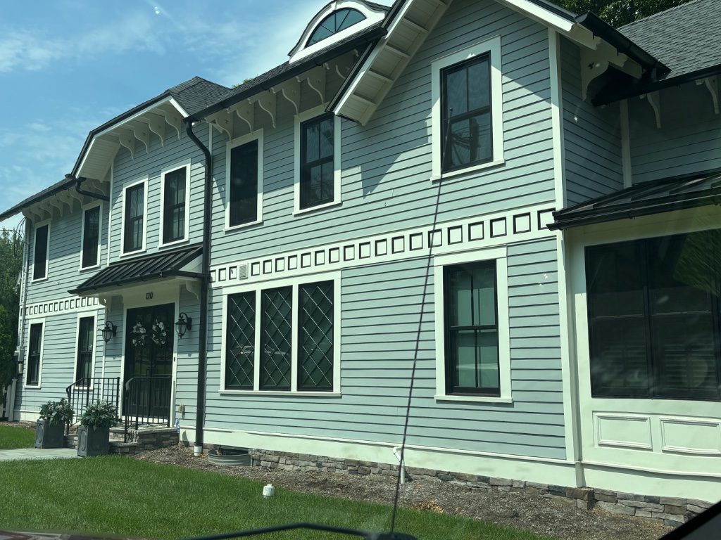 Exterior home with blue-grey siding and white trim