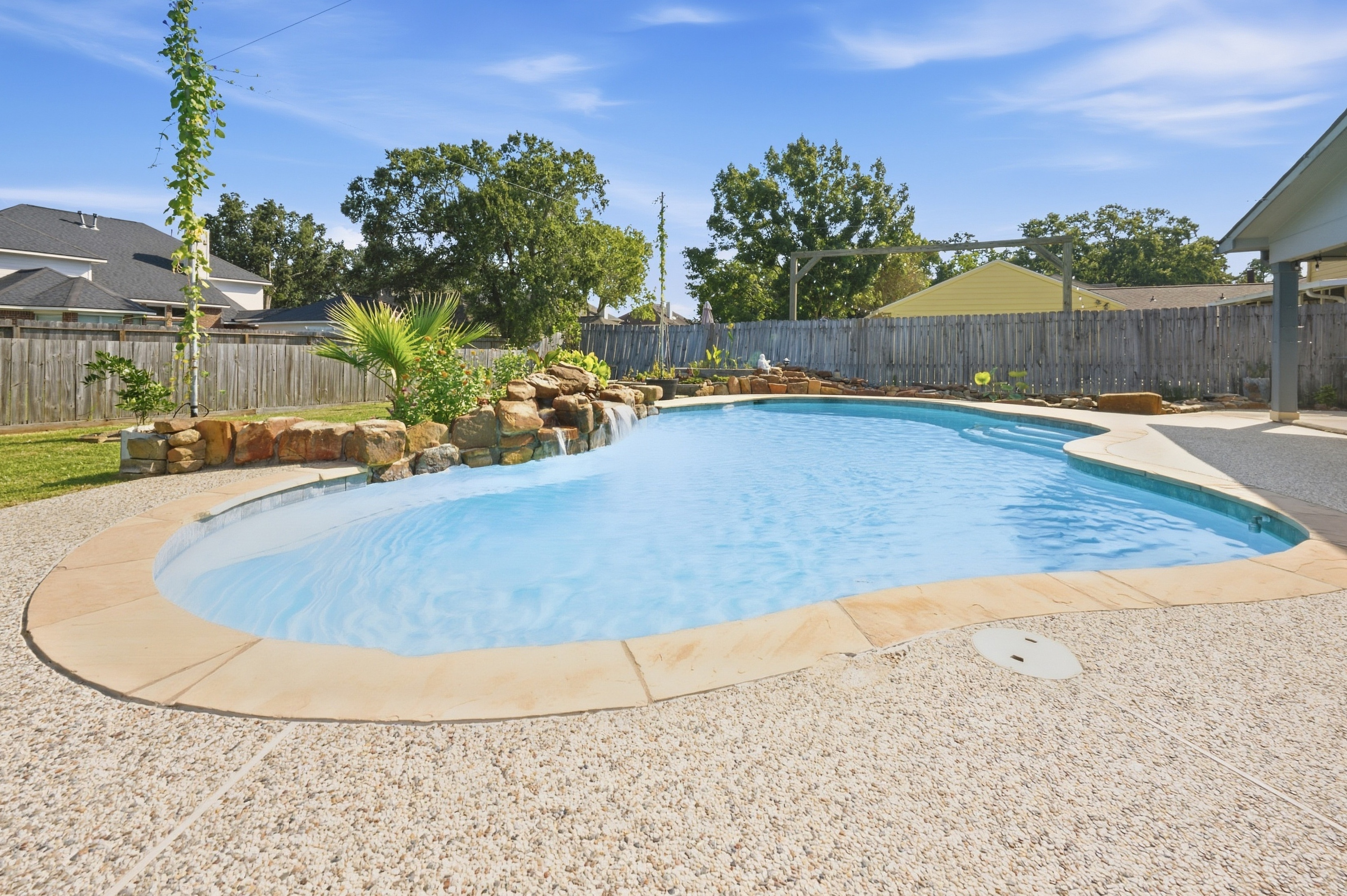 Backyard pool with rock waterfall