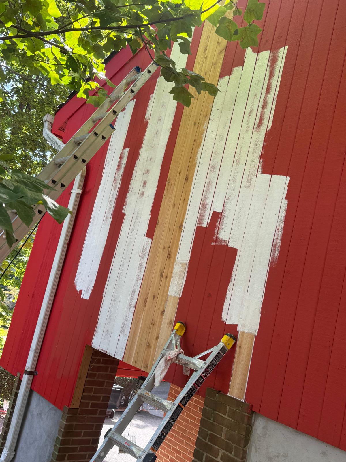 Exterior repair — new siding primed over the rebuilt section in Hartsdale
