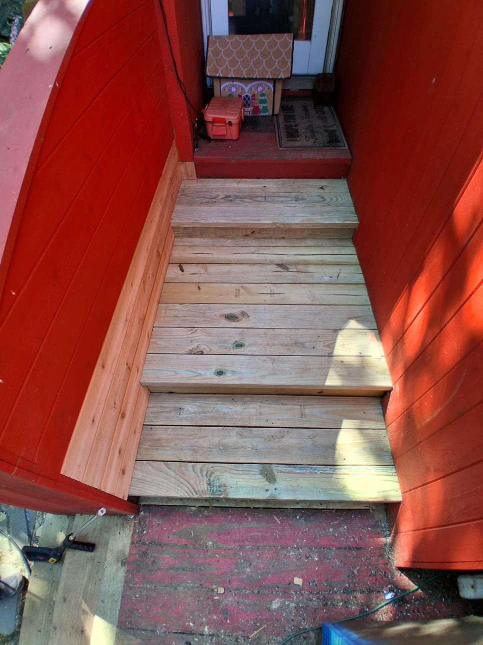 New deck stair treads set with vertical wood panel beside the steps in Hartsdale
