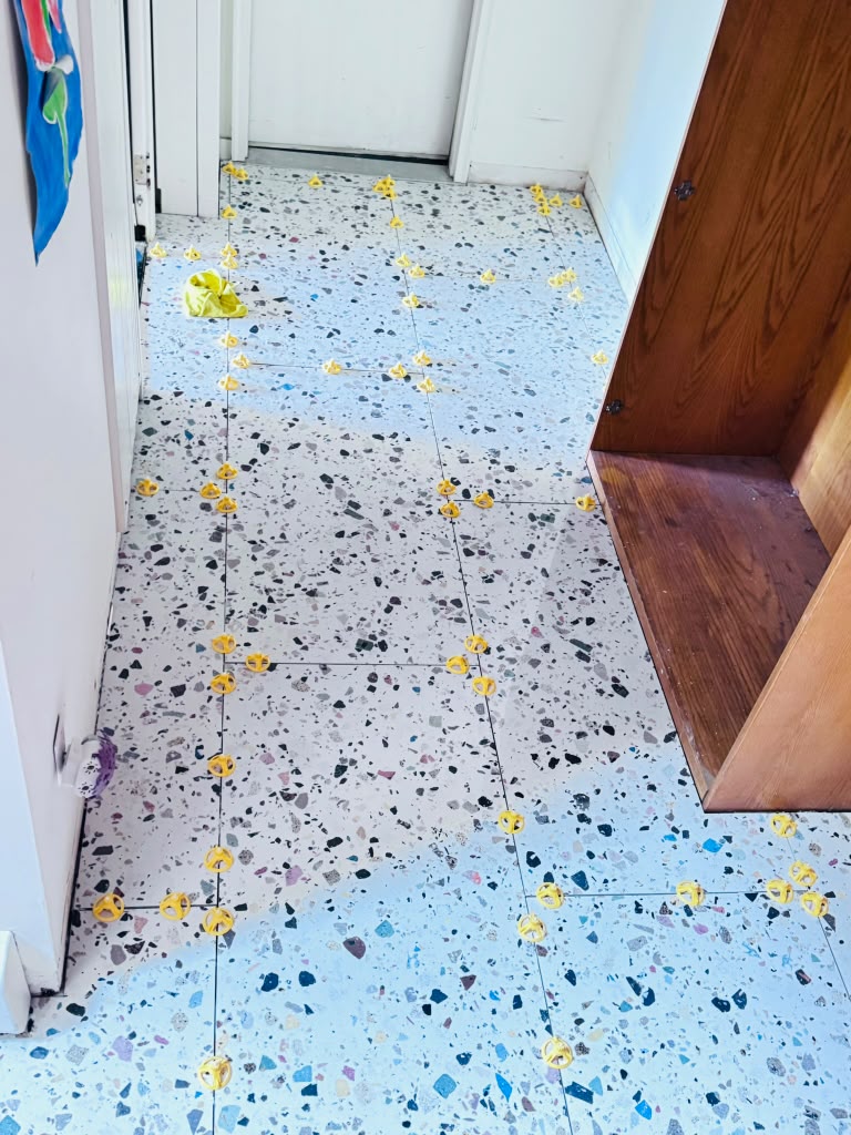 Terrazzo tile floor — hallway field with leveling clips in place in Hartsdale