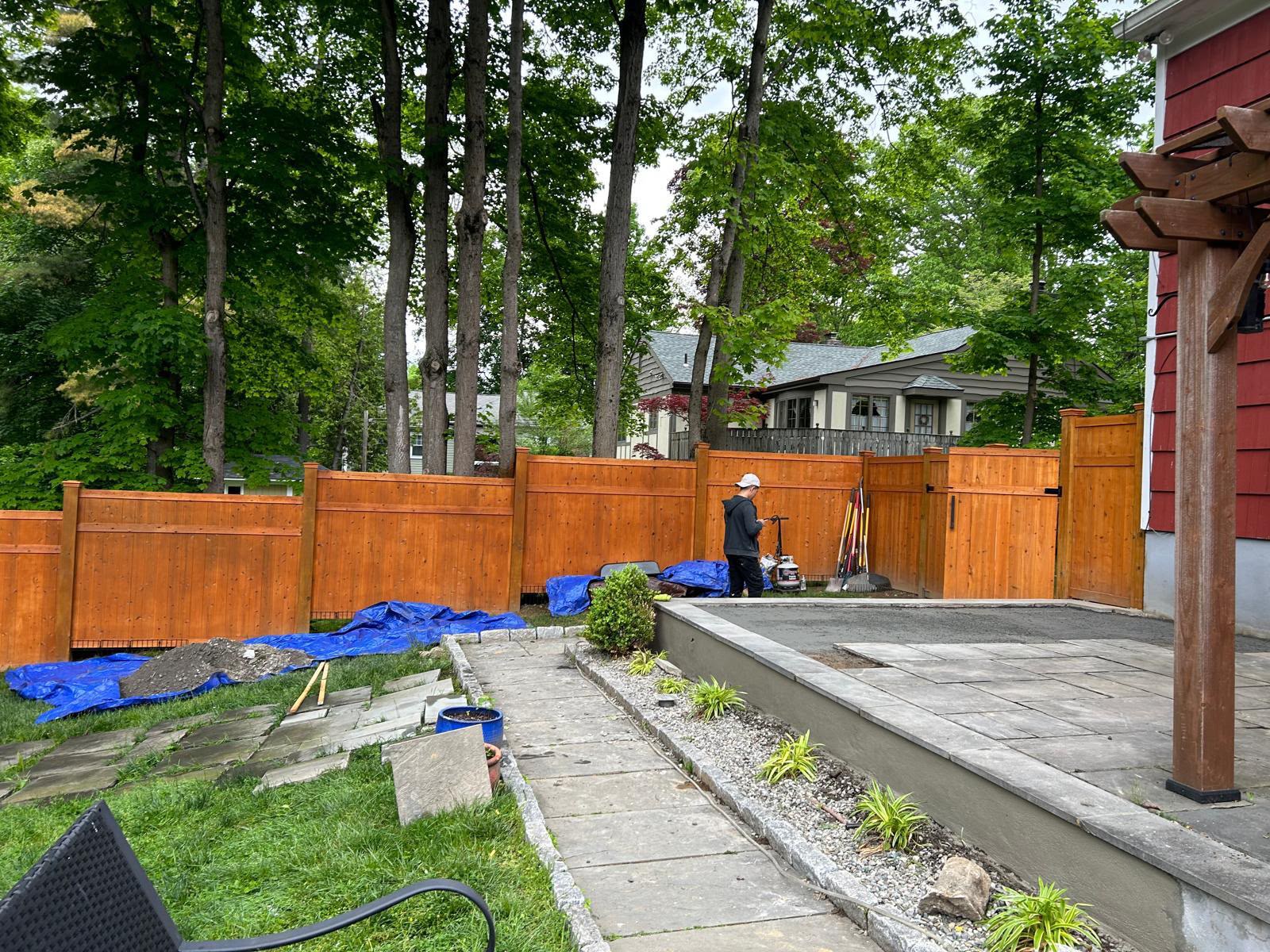 Cedar privacy fence and patio pour along the walkway in Mount Kisco