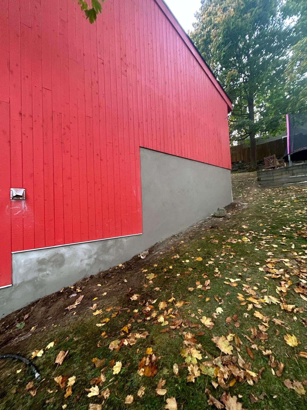 Exterior repair — finished siding above the repaired foundation base in Hartsdale