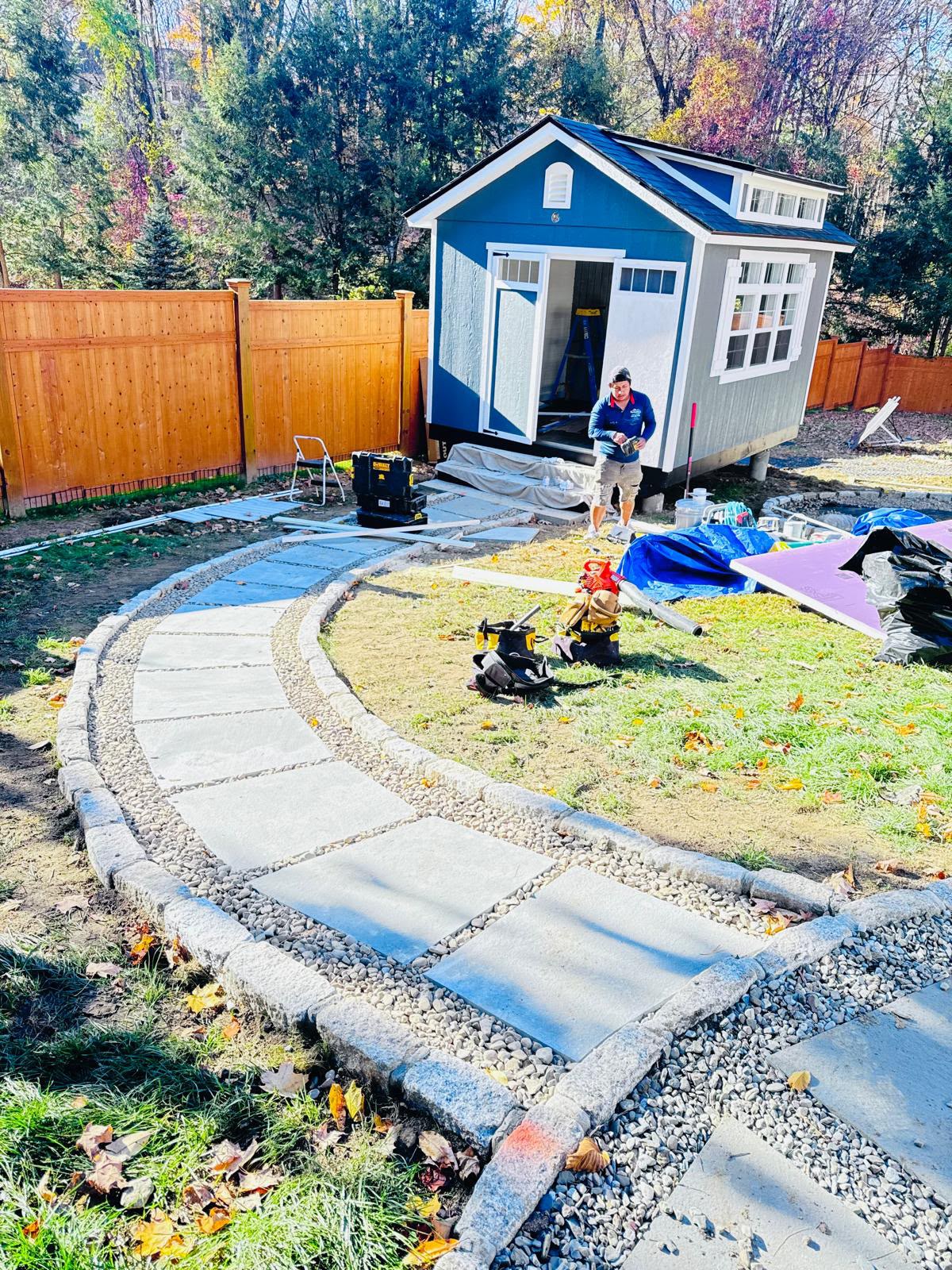 Stone walkway finished to the shed with new fence behind in Mount Kisco