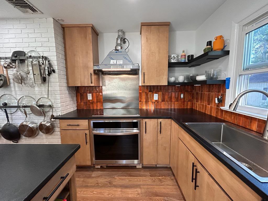 Finished kitchen with cookware wall on the brick in Mount Kisco