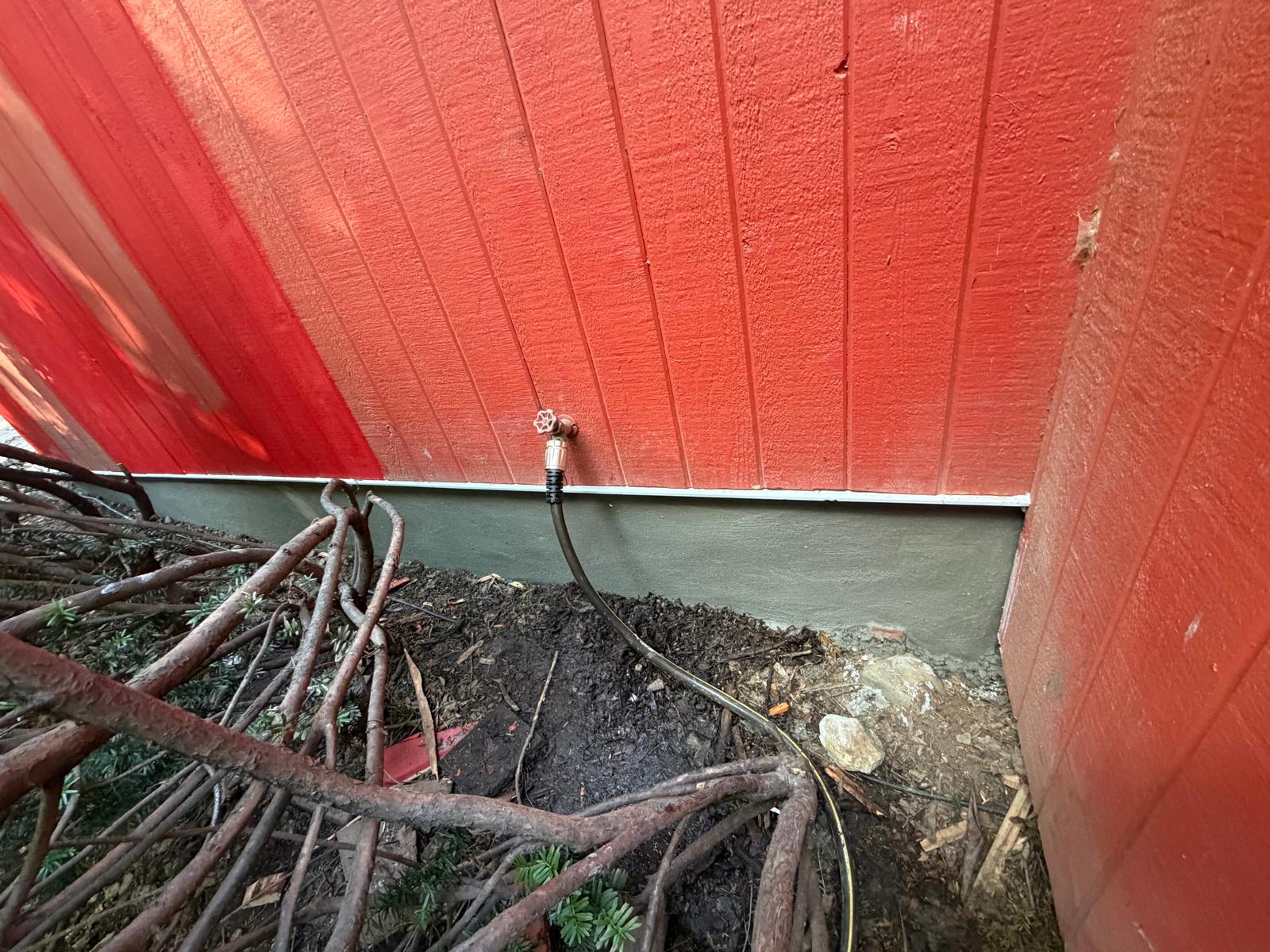 Exterior repair — siding rebuilt and foundation base patched in Hartsdale