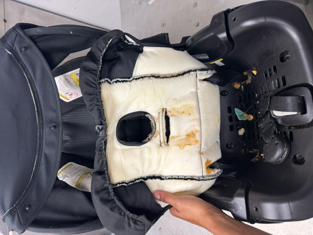 Soiled infant car seat — before professional restoration