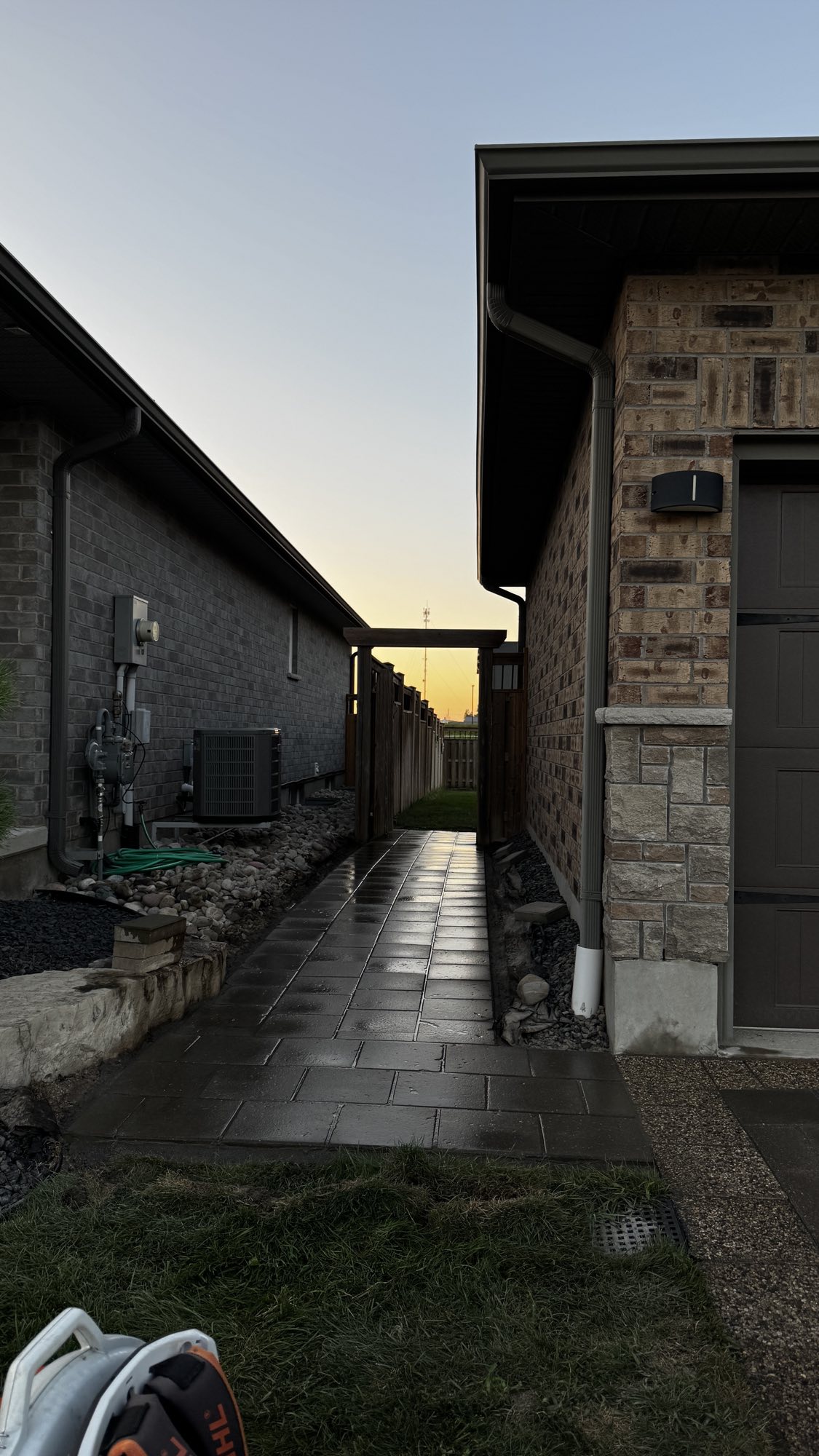 Side yard walkway after — level, clean-laid pavers with drainage beds