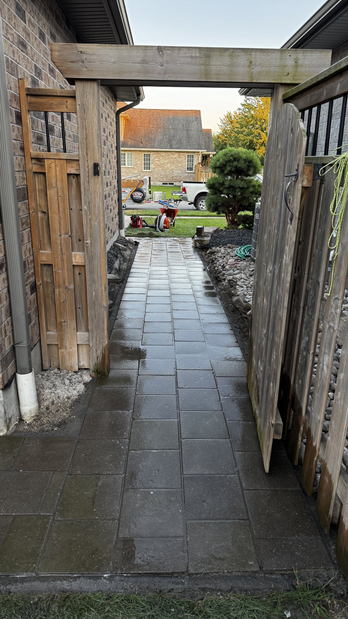 Side yard walkway after — level, clean-laid pavers with drainage beds