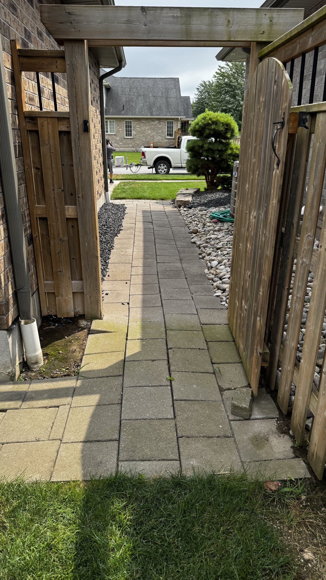 Side yard walkway before — settled, mossy pavers