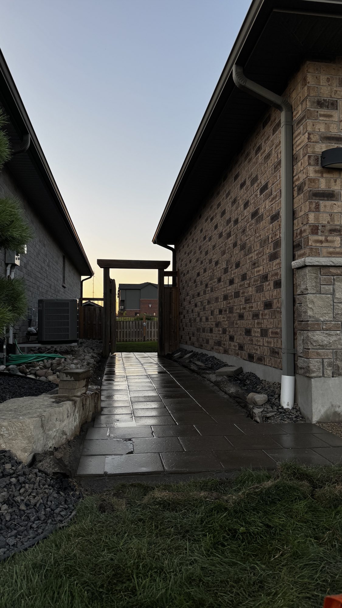 Side yard walkway after — level, clean-laid pavers with drainage beds
