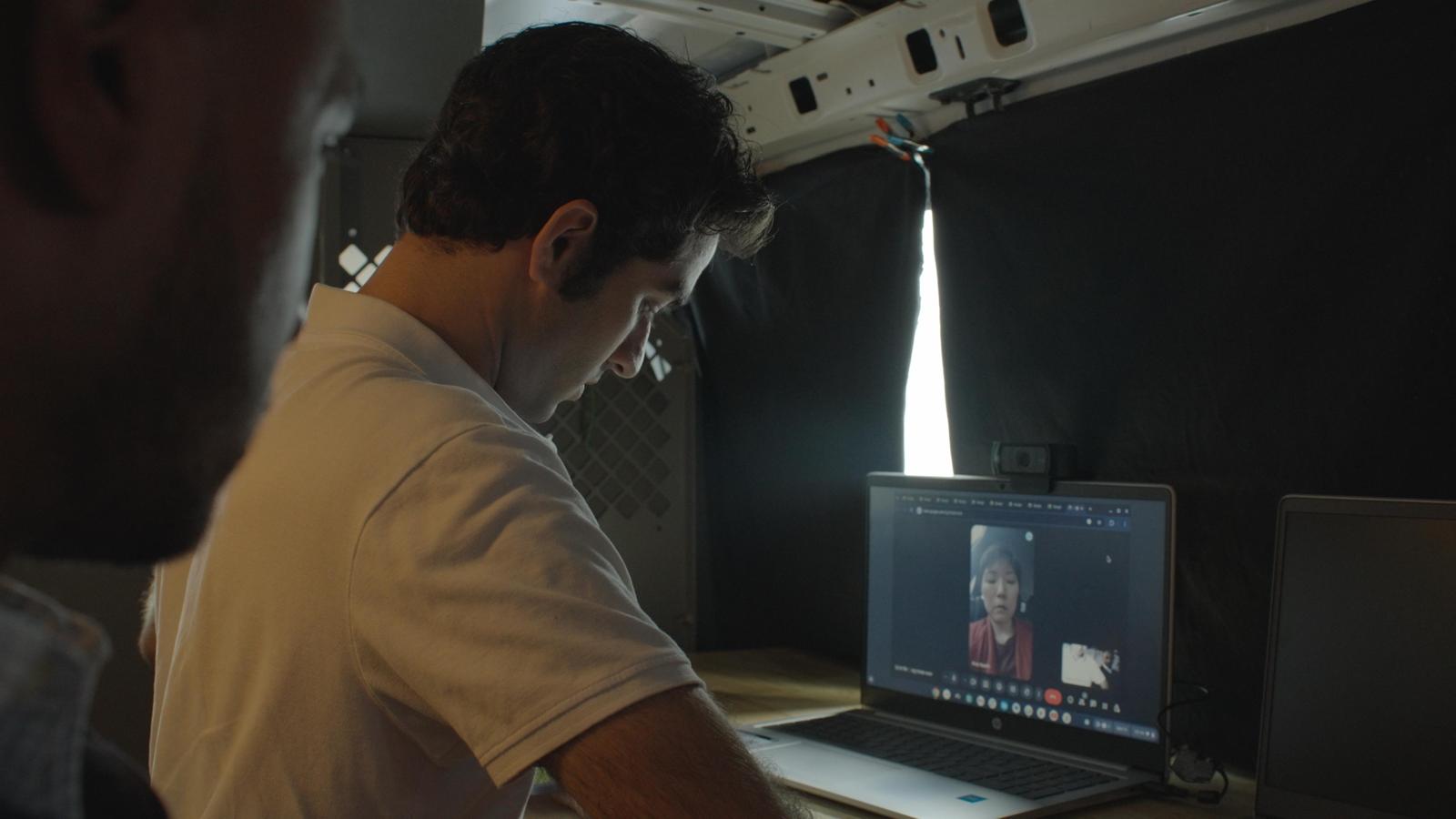 Investigator on a video call from inside the production van, production still from the film Doctored