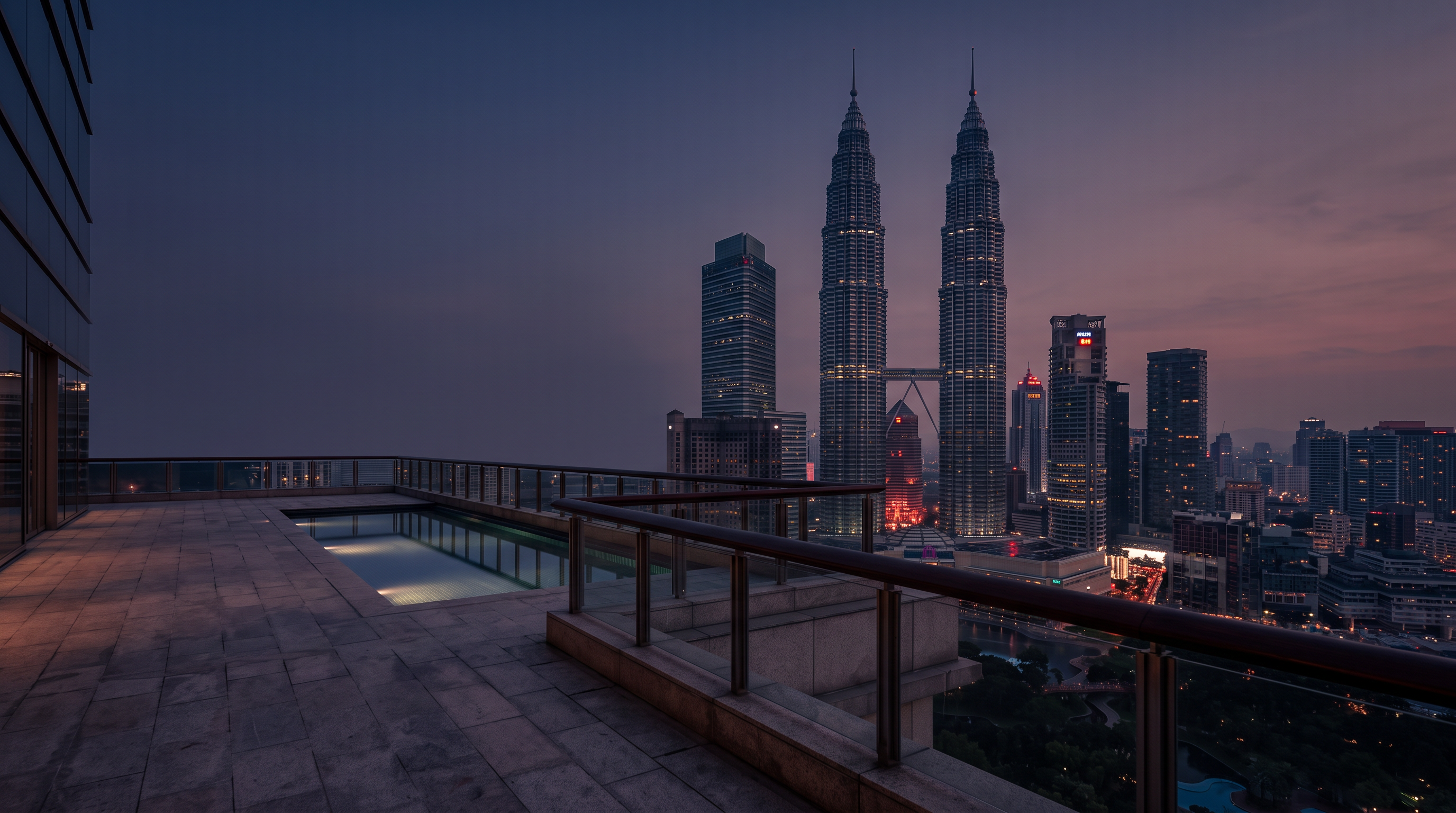 Petronas Towers and the Kuala Lumpur skyline at blue hour, viewed from an elevated terrace