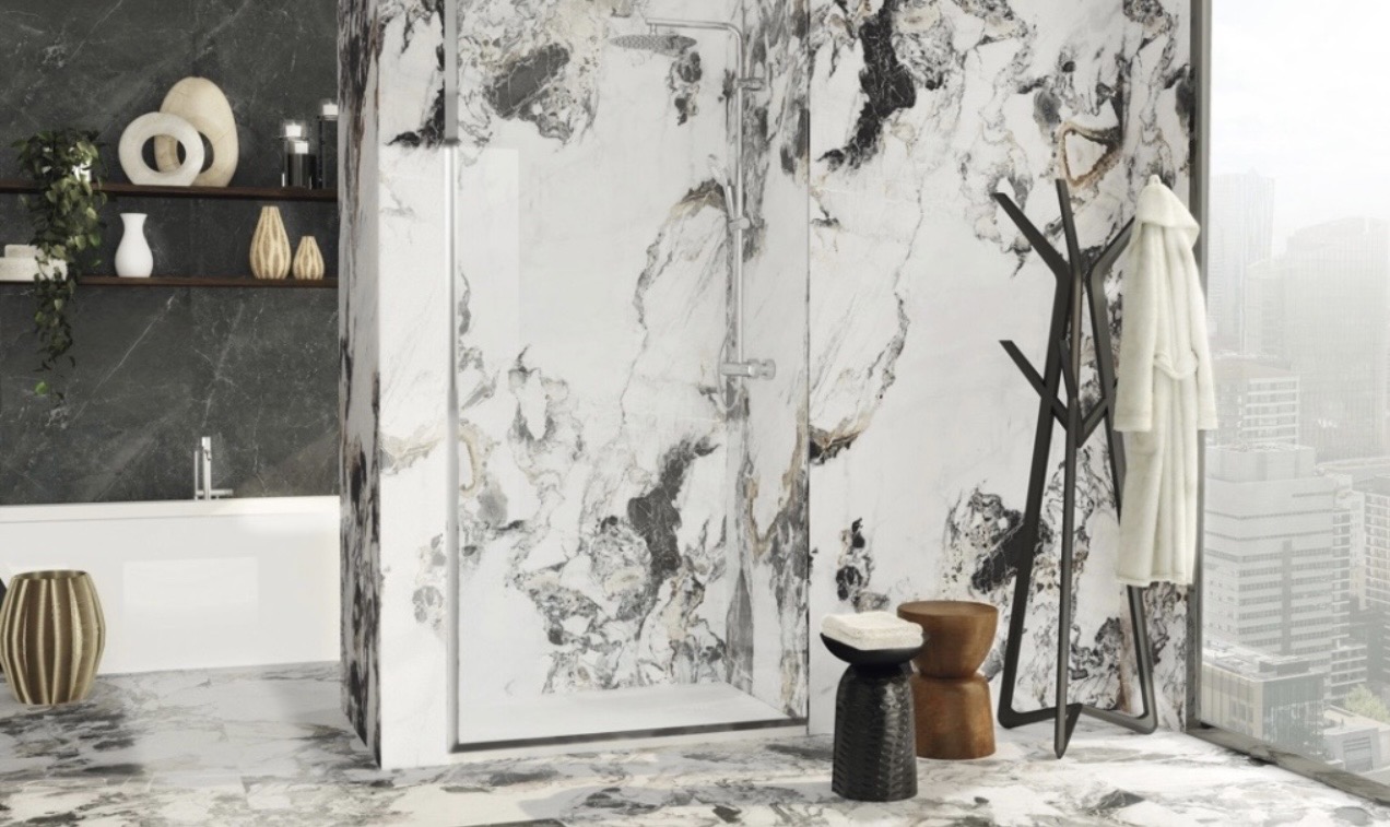 Luxury bathroom with bold black and grey veined marble surfaces and glass-enclosed shower